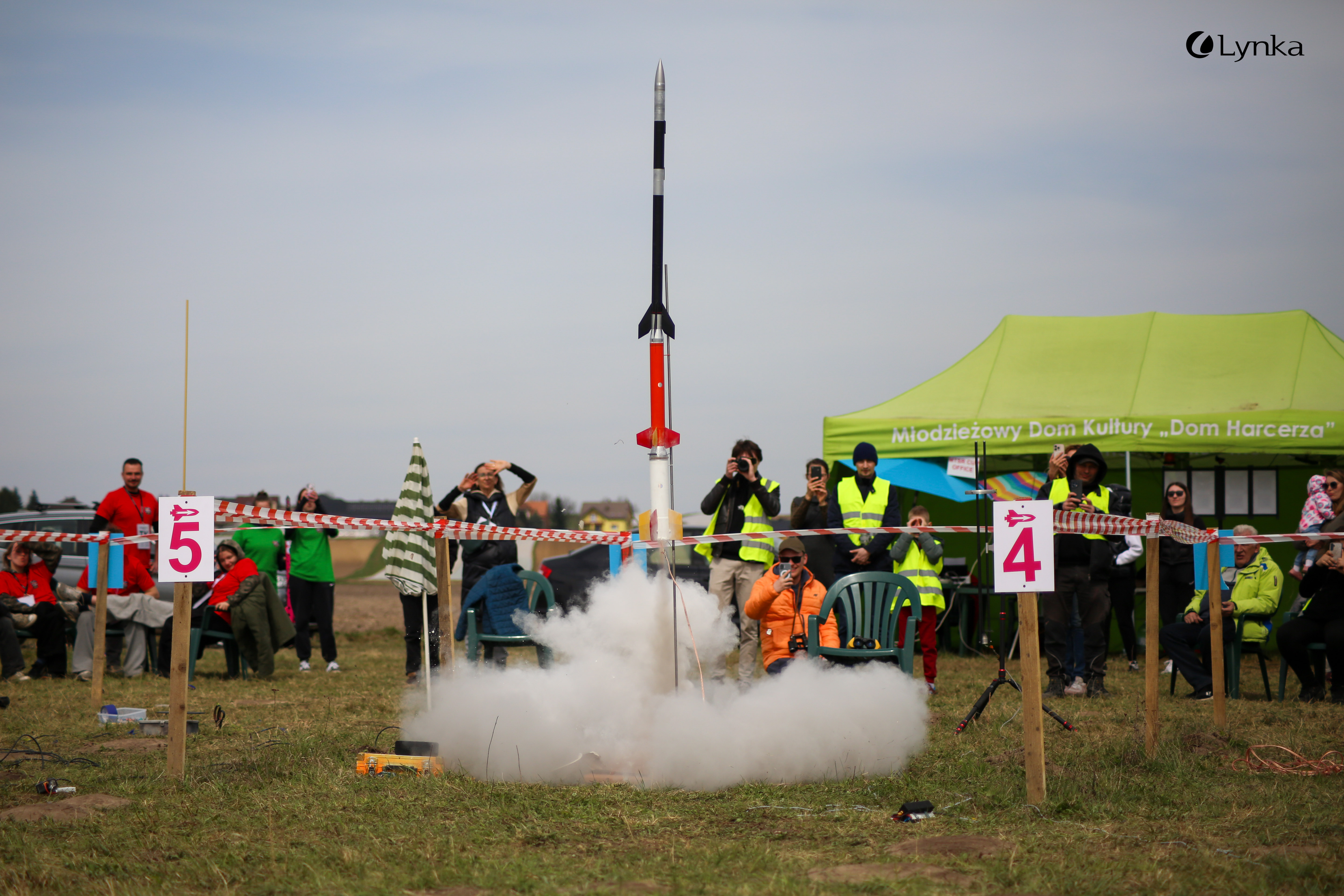 Launch of a model rocket from a field, creating a large cloud of white smoke at the MTSR Sowiniec Cup 2026.